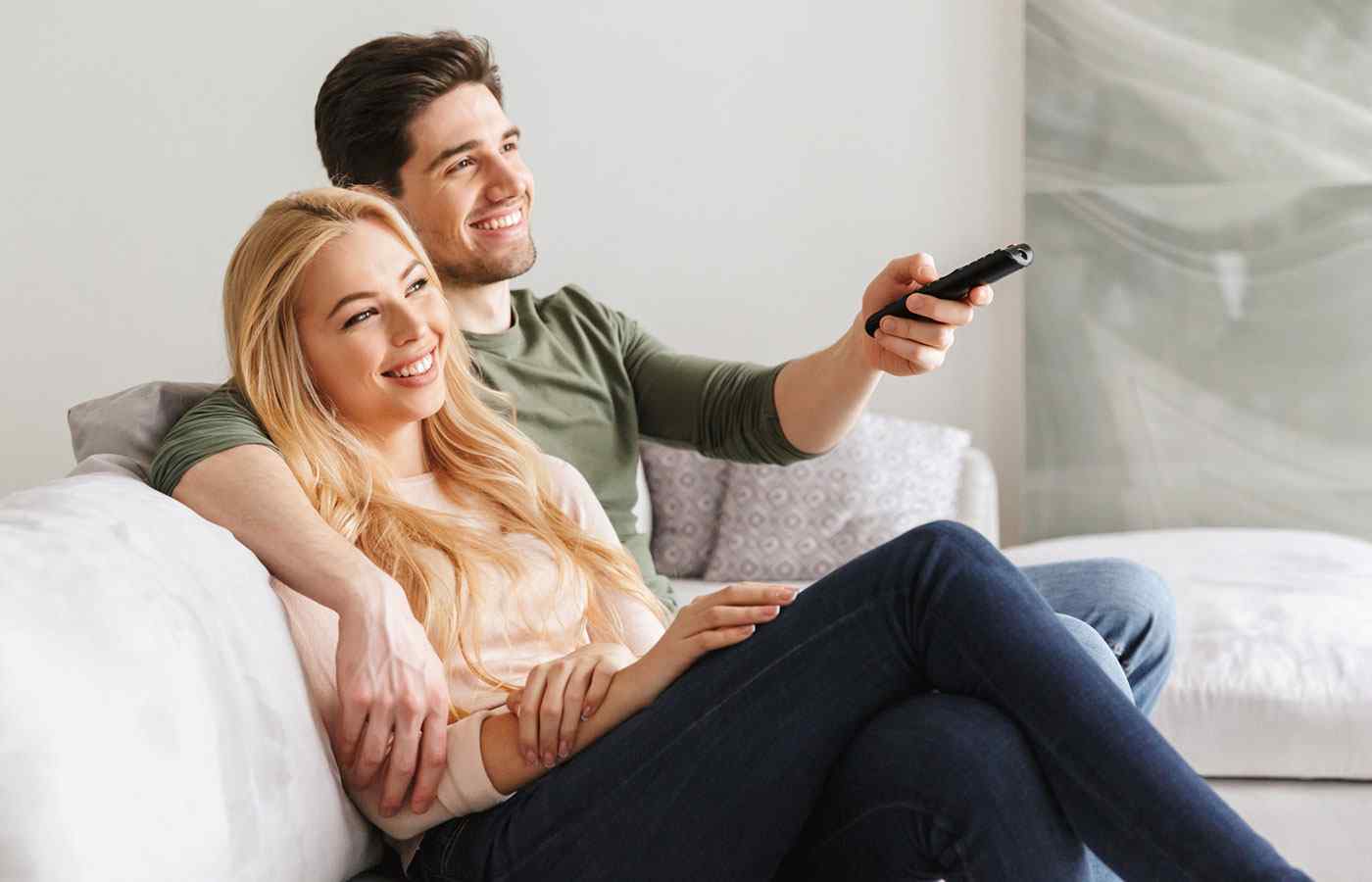 young couple streaming films together on the sofa