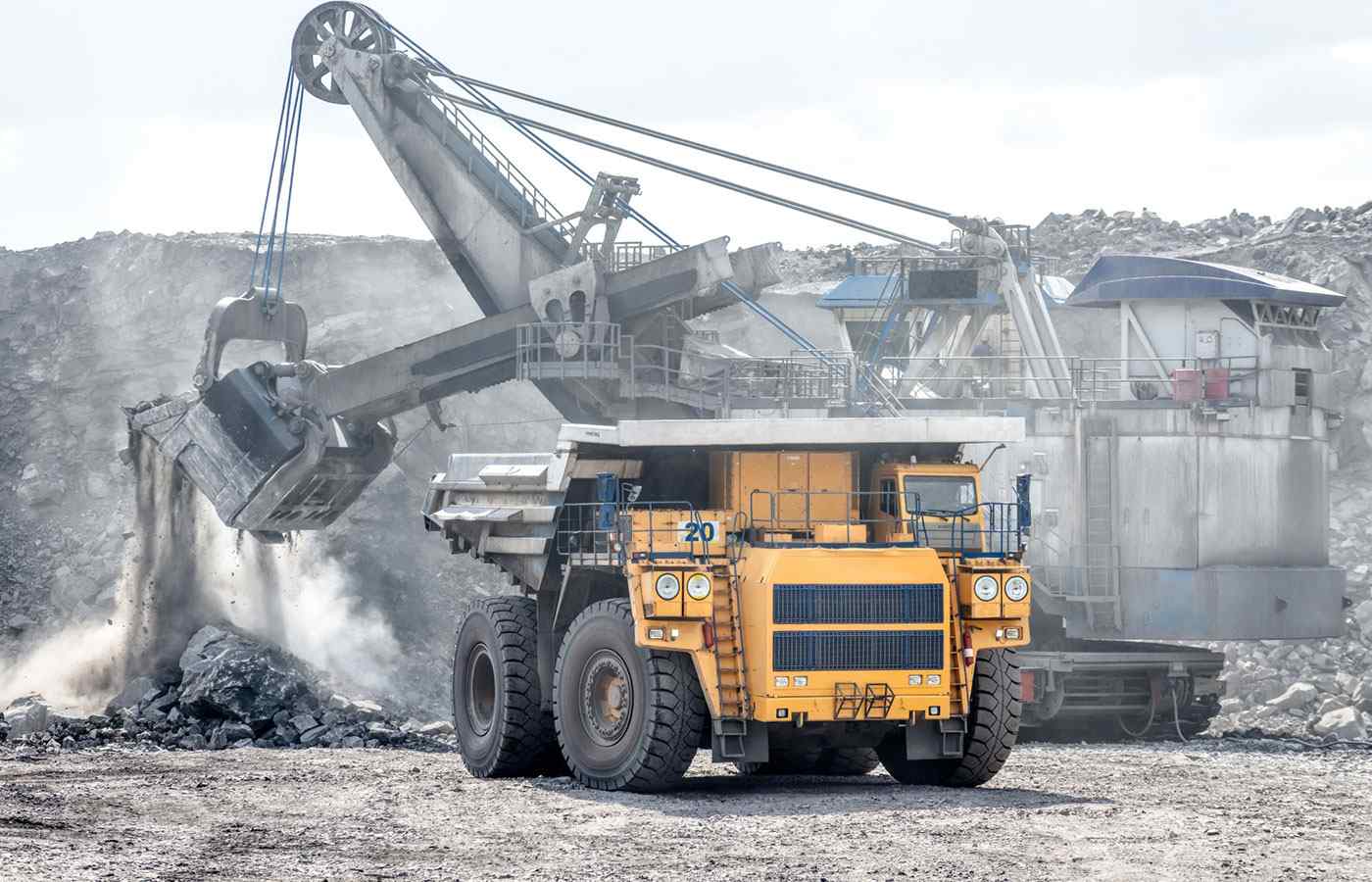 diggers extracting materials from the ground at a mining site