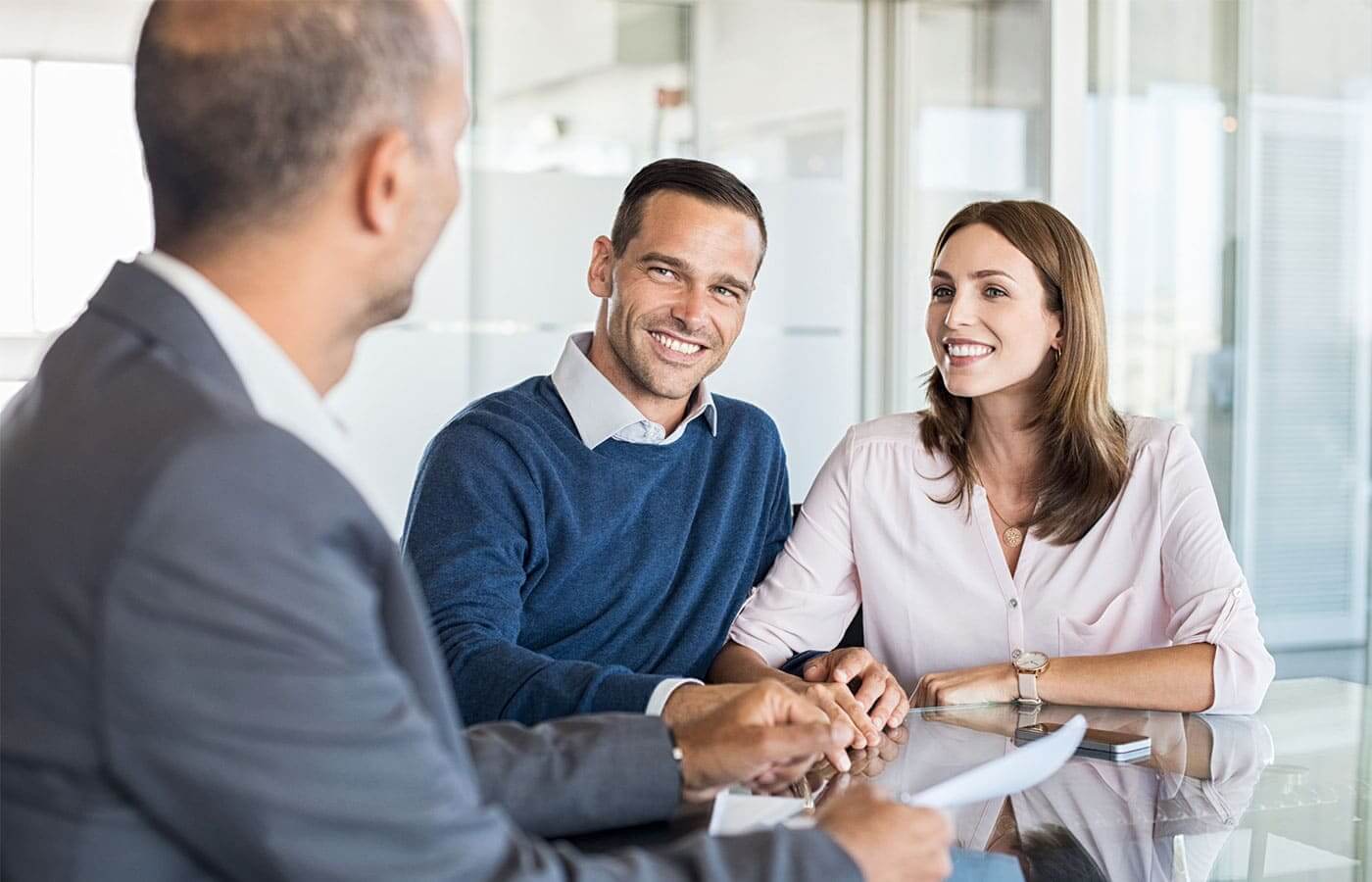A young couple speaking to an investment advisor