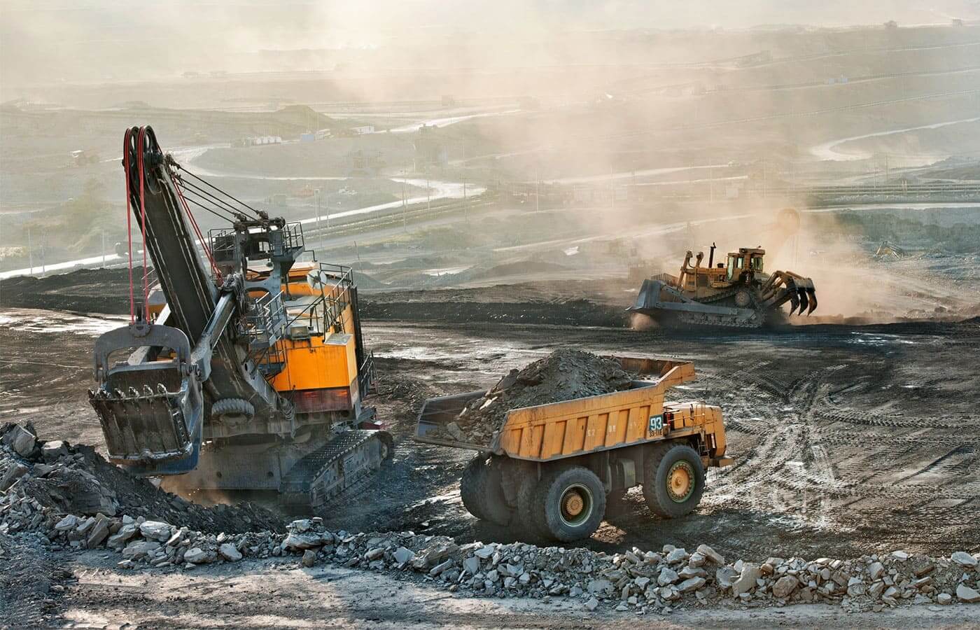 Heavy earthmovers in a coal mine excavating resources