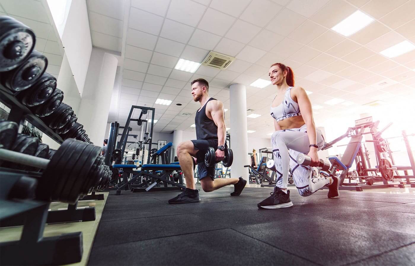 A young couple doing exercise in the gym together