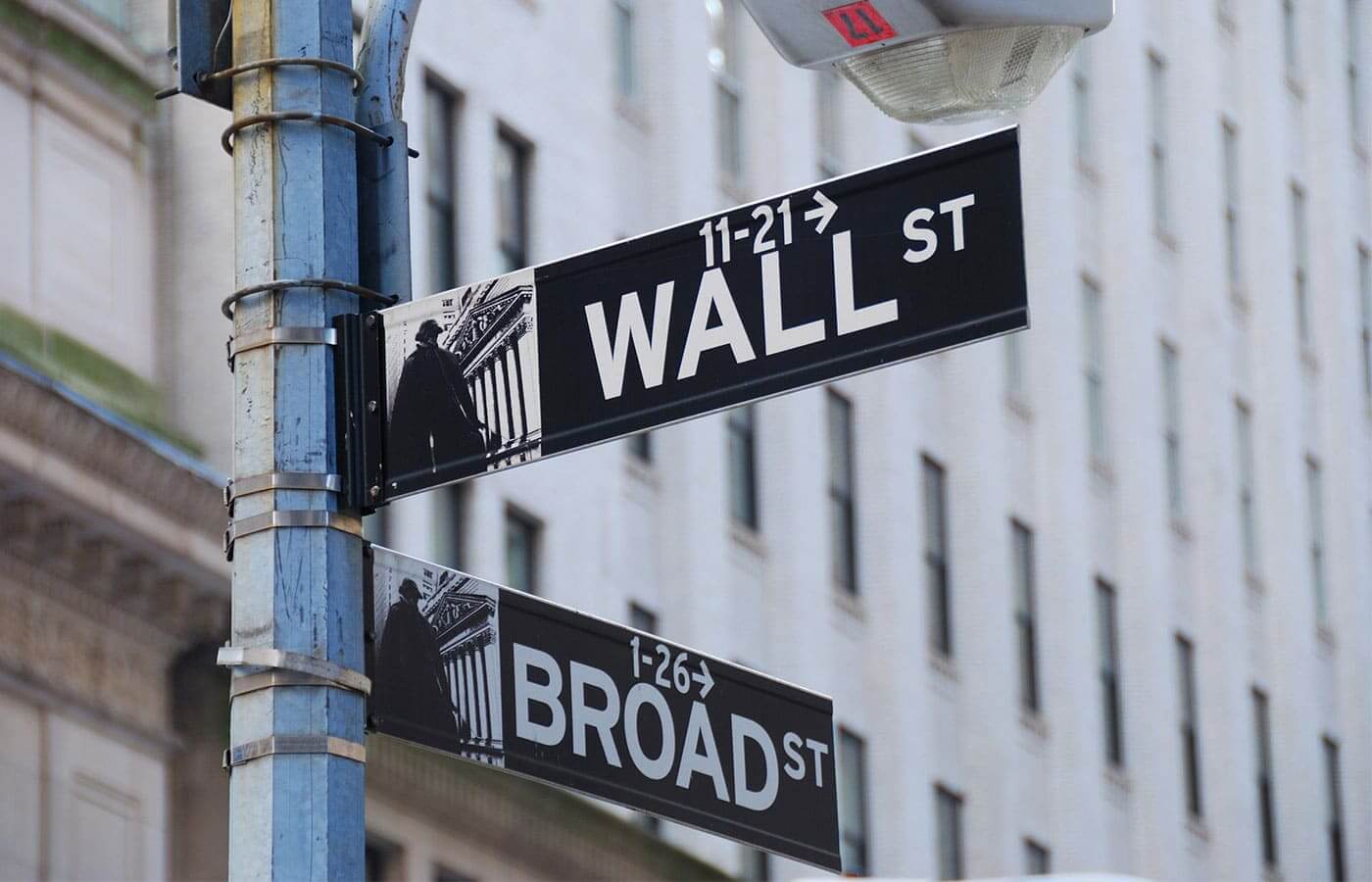 A sign in New York City pointing the way to Wall Street