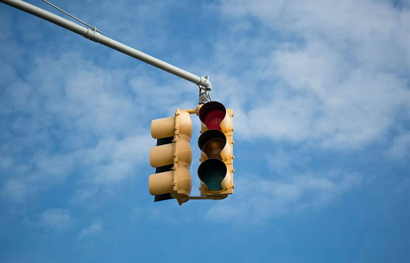 A traffic light showing red on a clear sunny day
