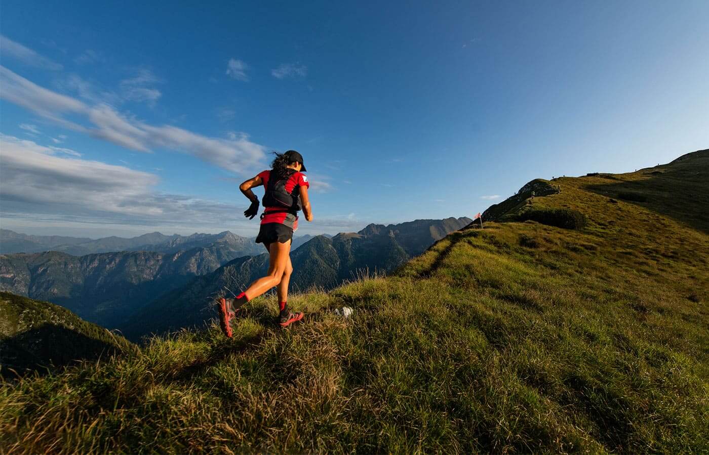 Sporty woman running on trials in the mountains