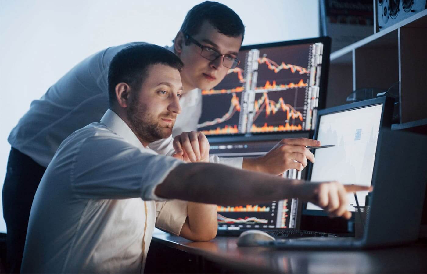 Young traders looking at stock market patterns to build an investment strategy