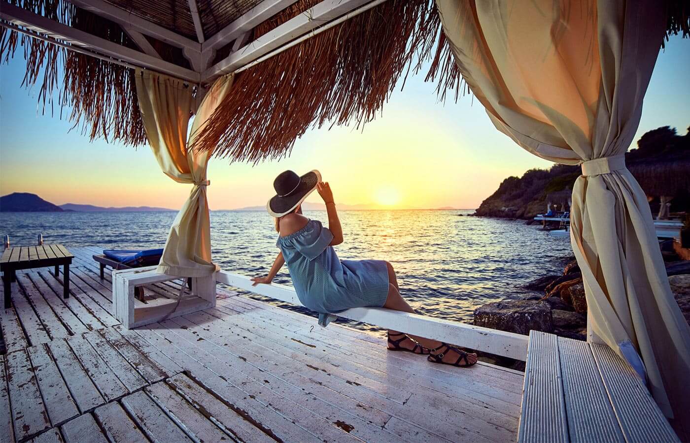 Young rich woman relaxing at sunset